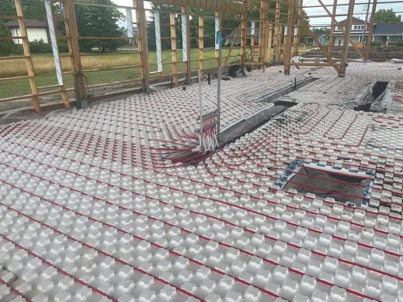 In-floor radiant heating PEX tubing layout on insulation panels before concrete pour